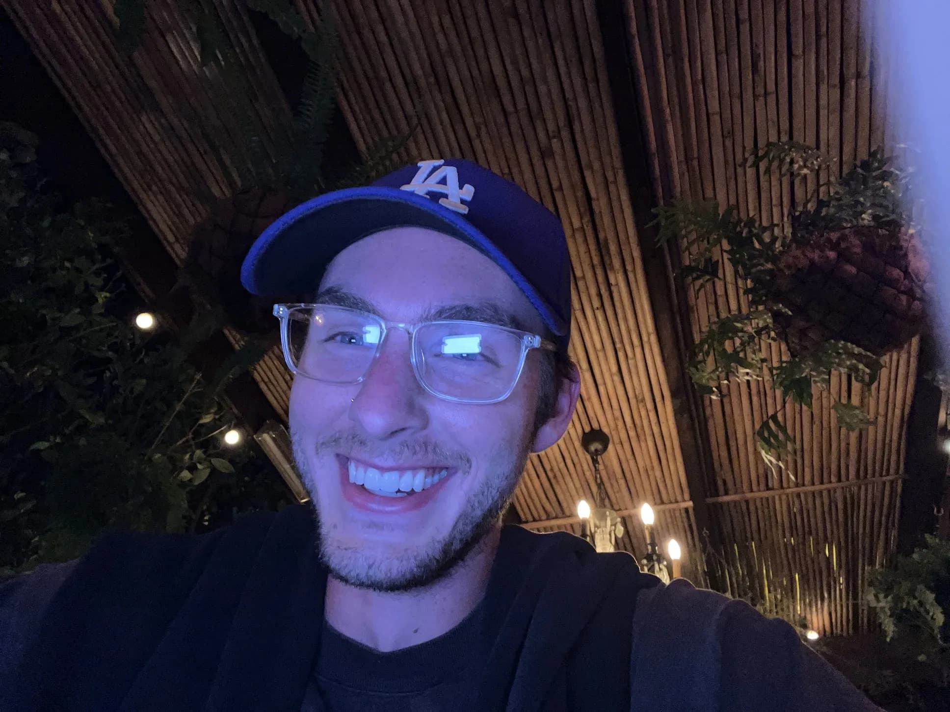 Zack Allen wearing glasses at an evening venue