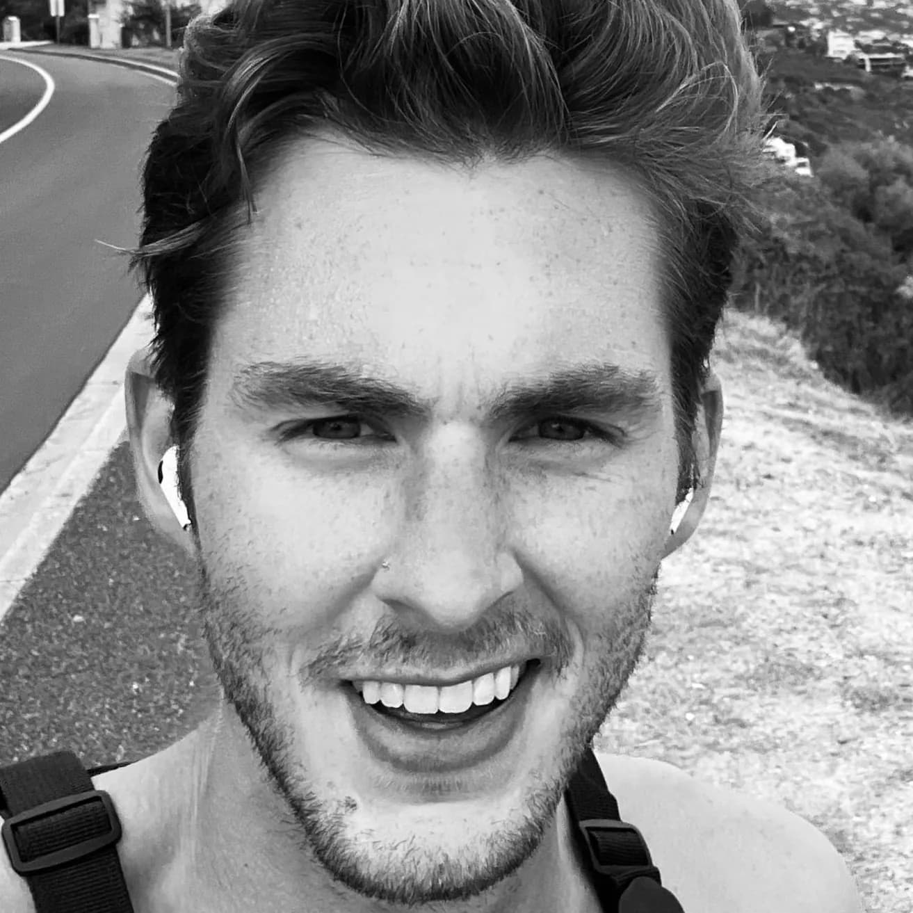 Black and white outdoor headshot of Zack Allen